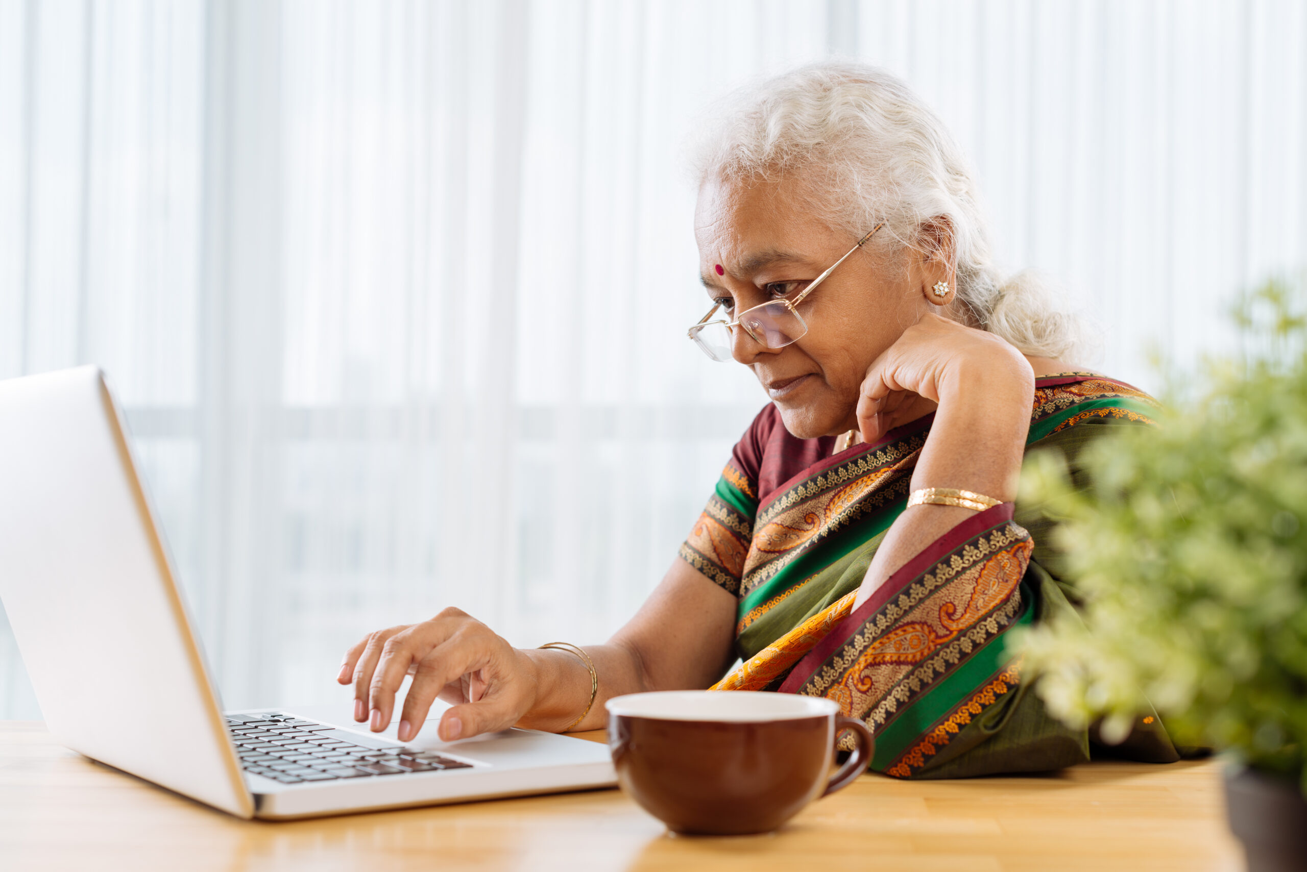 Elderly working on laptop after Senocare professional training
