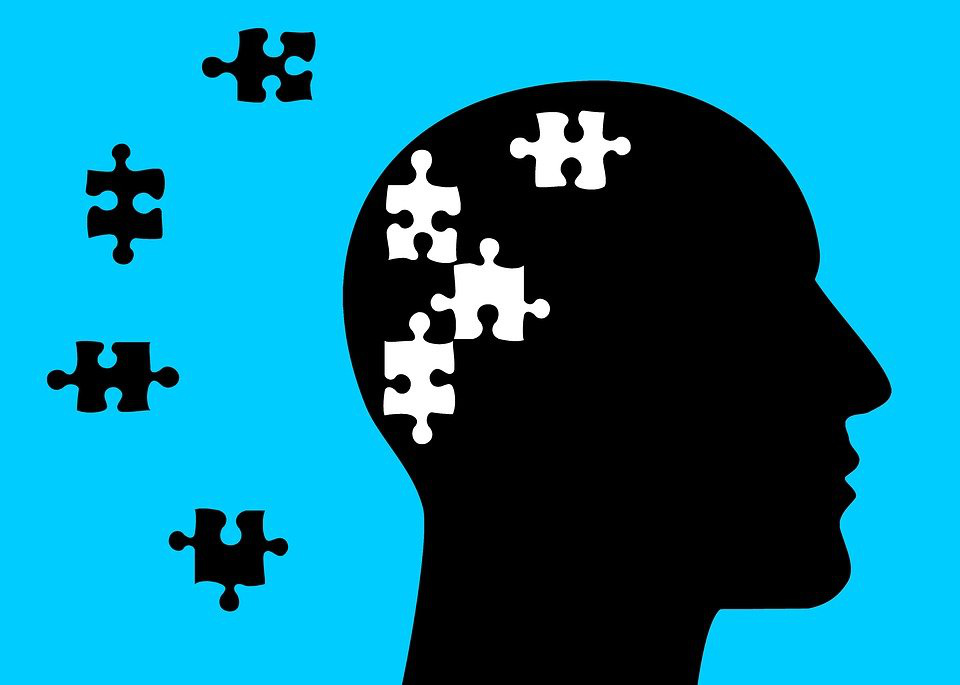 An illustration with a silhouette of a head with puzzle pieces
