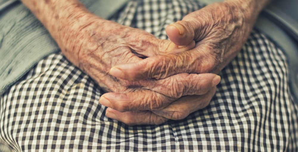 An elderly woman with wrinkly hands